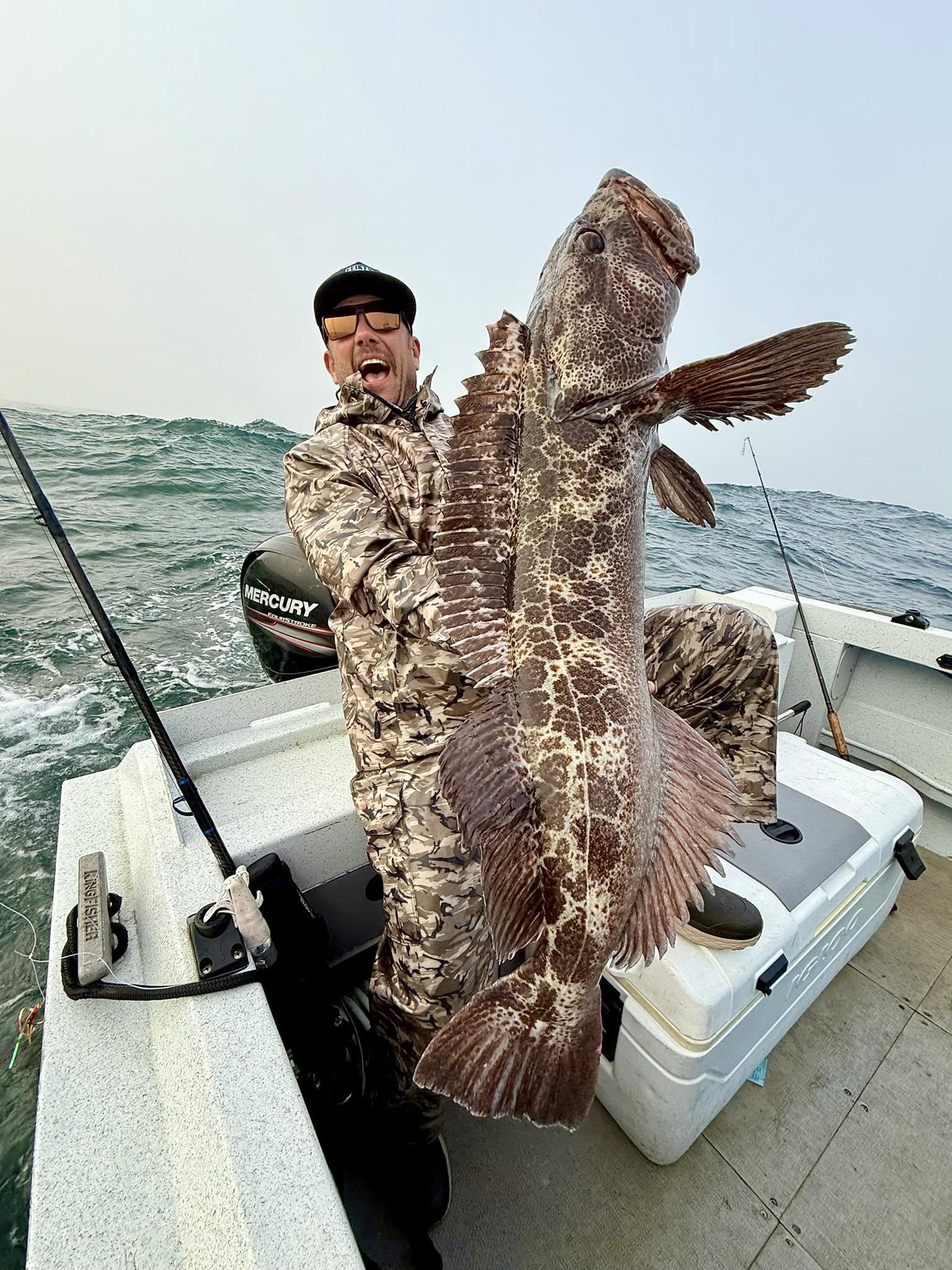 Scott Feist celebrating with a large Gold Beach lingcod