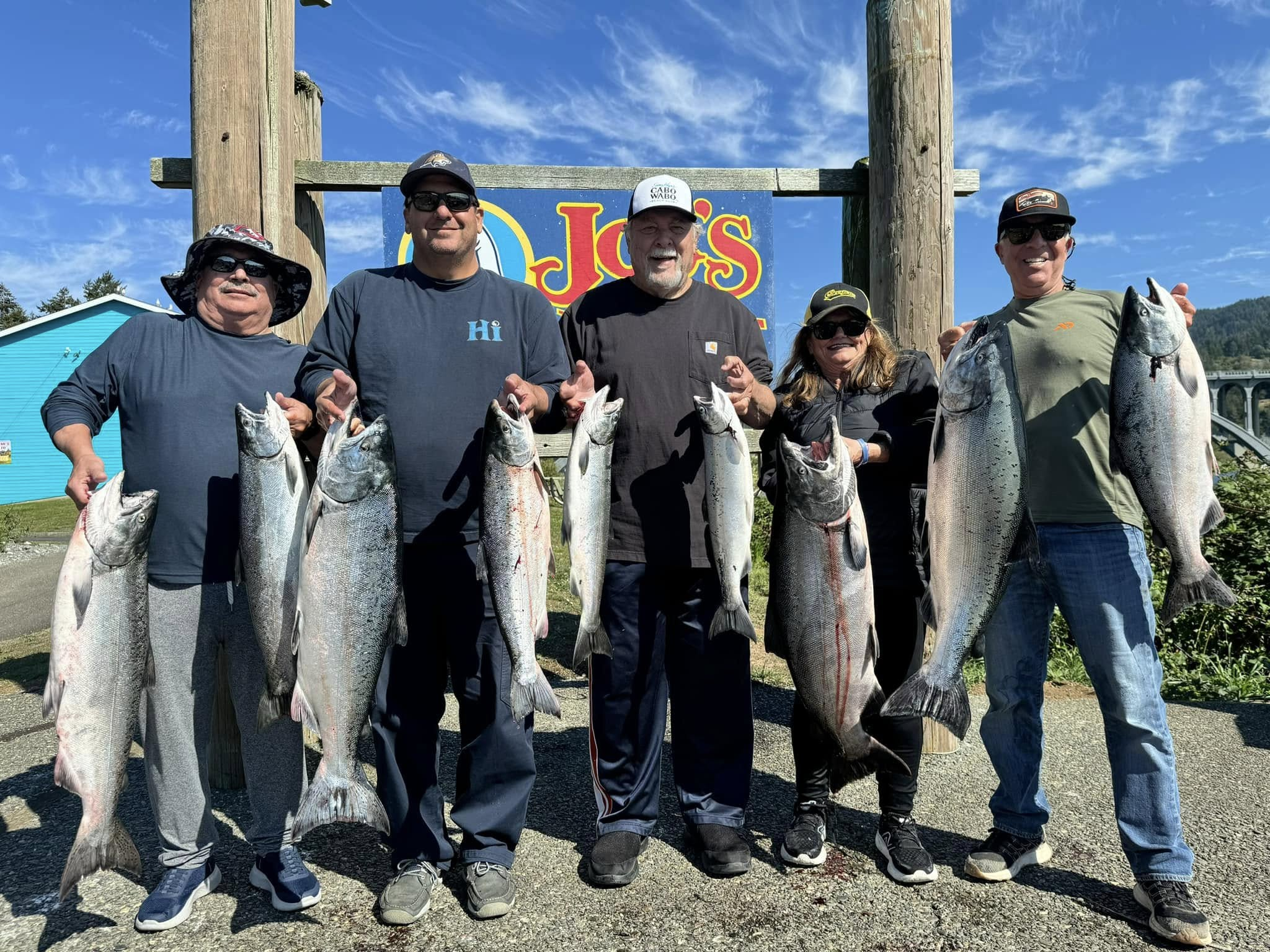 Five Gold Beach anglers displaying their salmon catch at the dock