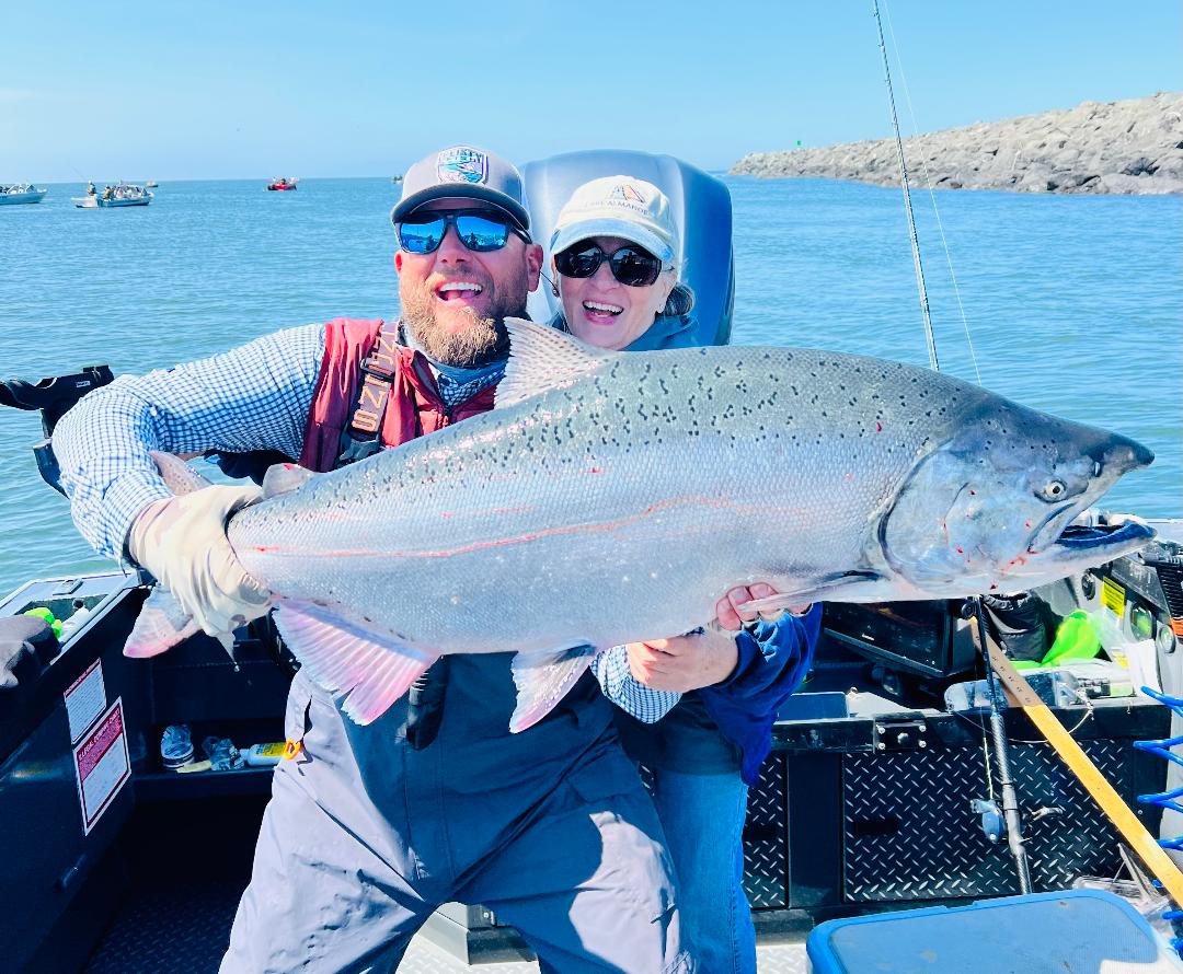 Scott Feist and a guest holding a large Gold Beach salmon