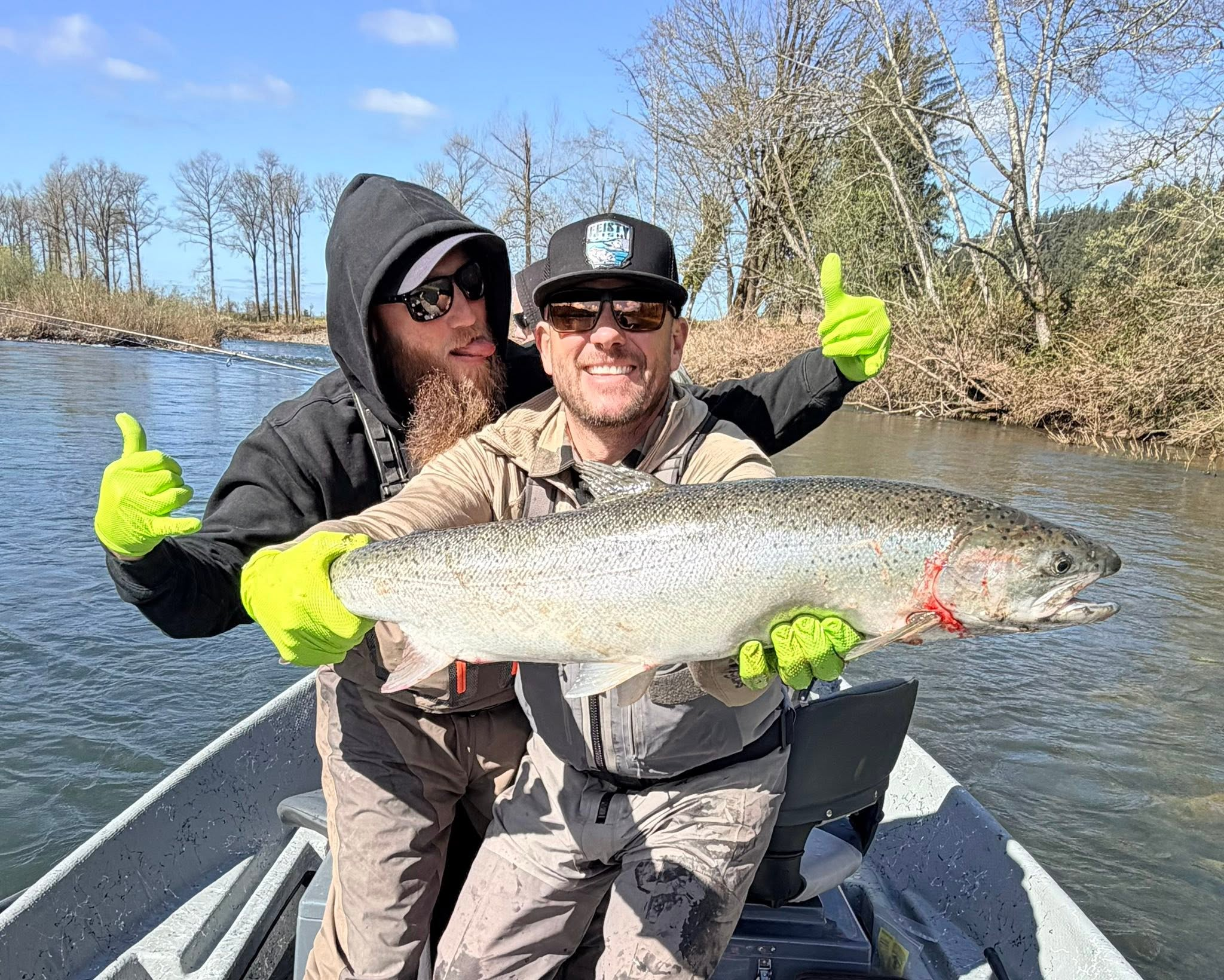 Scott Feist and a guest holding a winter steelhead on a Tillamook-area river